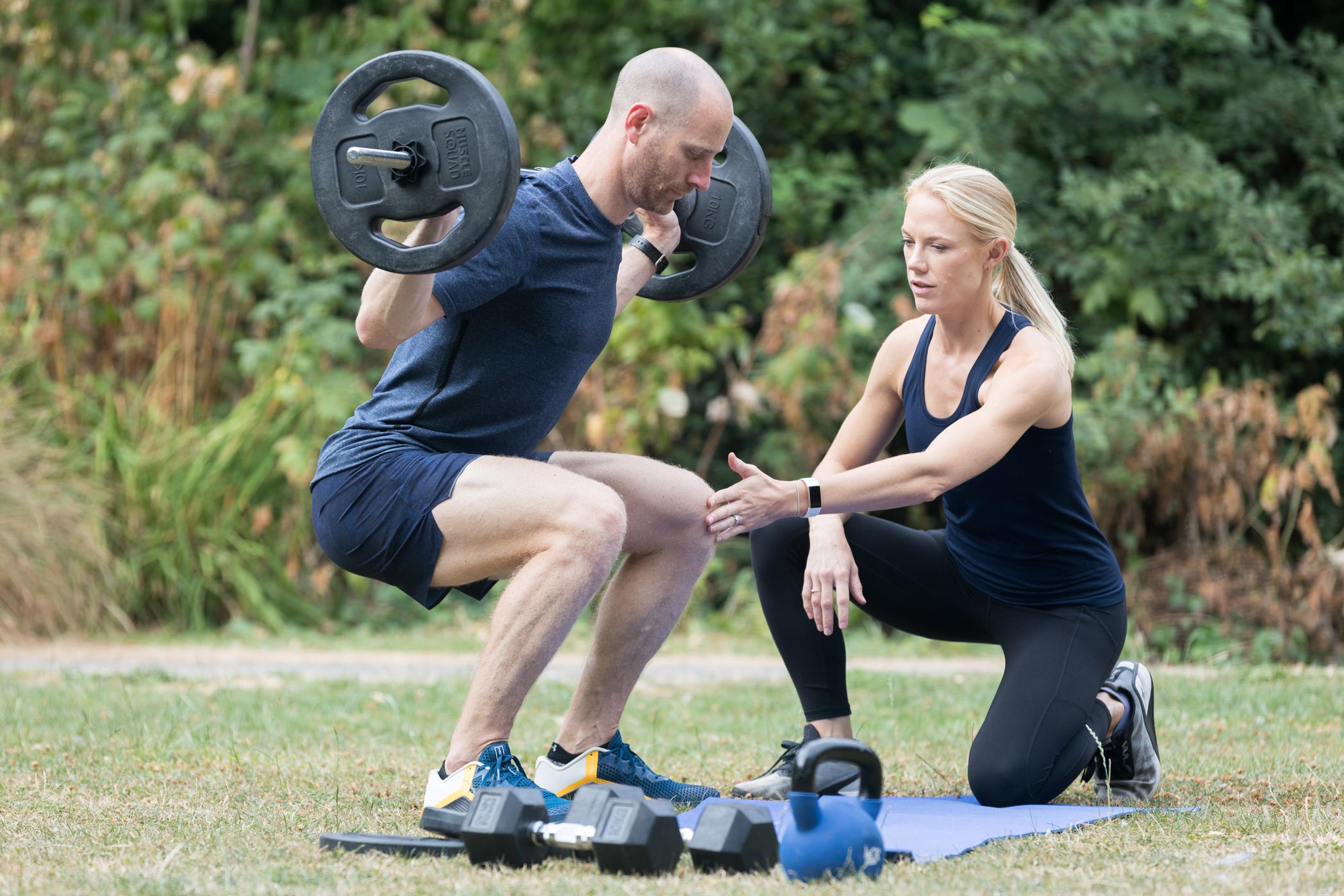 A personal trainer works with her client during a personal branding health & fitness photography shoot in Croydon, London