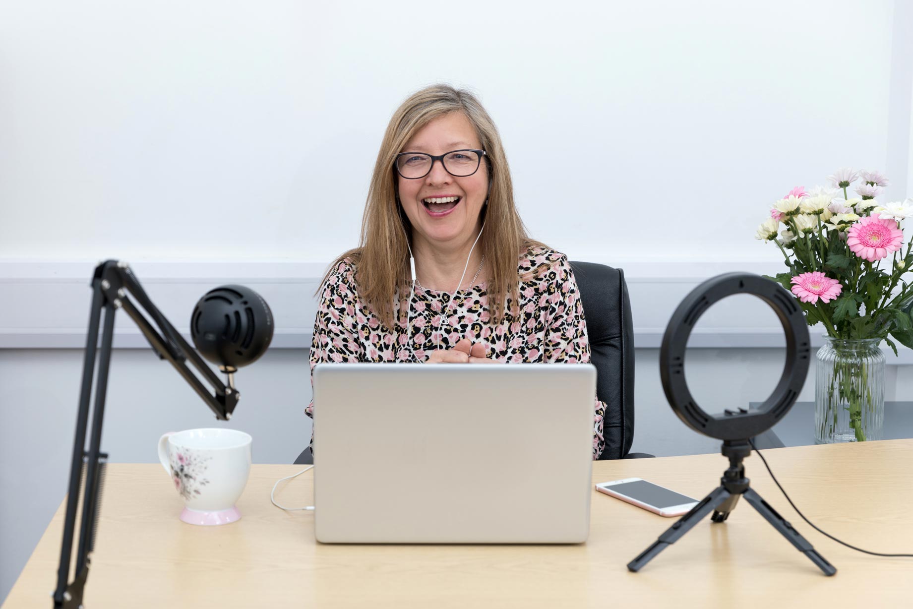 A woman recording her podcast during her personal branding photography shoot in Croydon