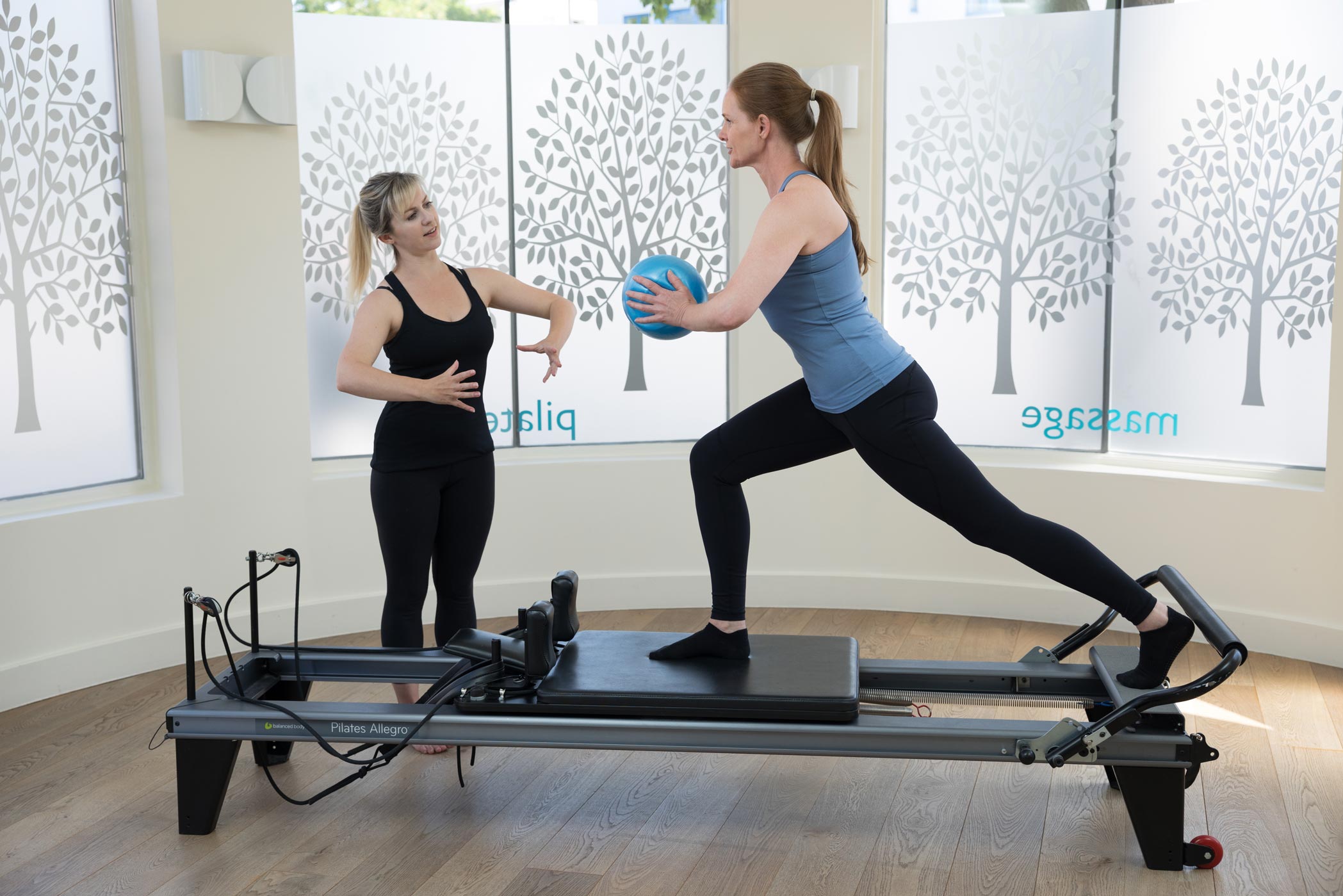 A reformer pilates class at an exercise studio in Balham, London during a health & fitness personal branding photography shoot