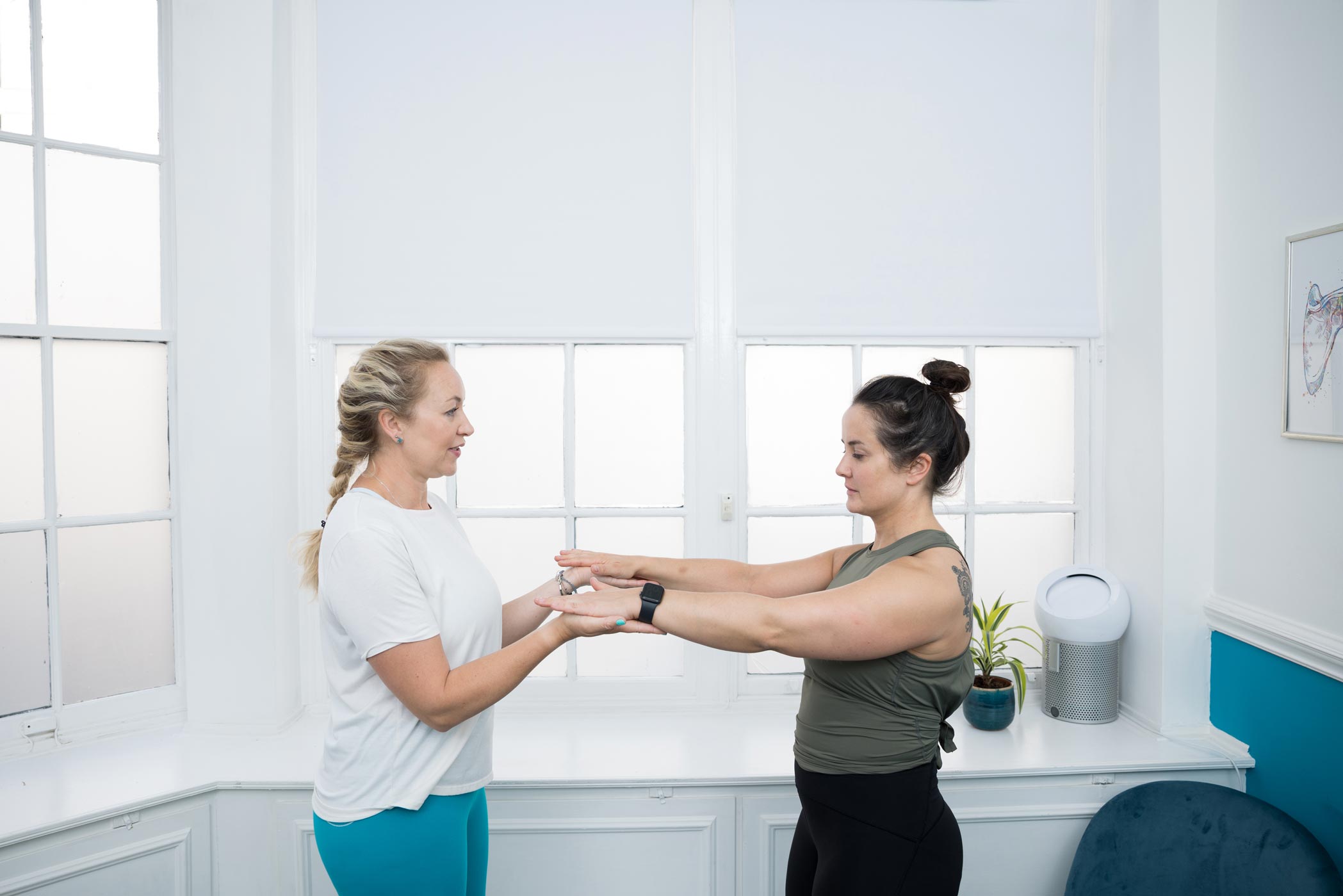 A therapist treats her client at a clinic in London Bridge during a health & fitness personal branding photography shoot