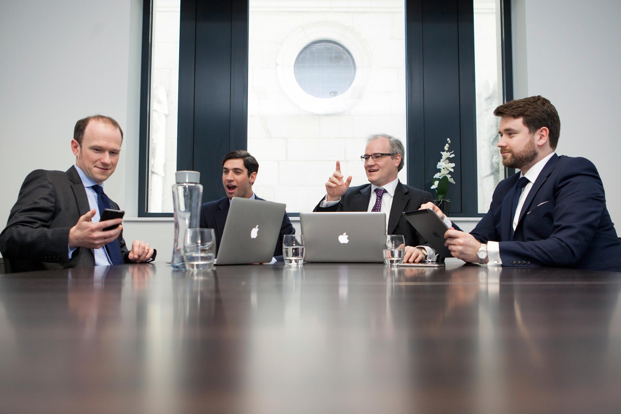 A group of men in a business meeting in London showing an example of branding photography.