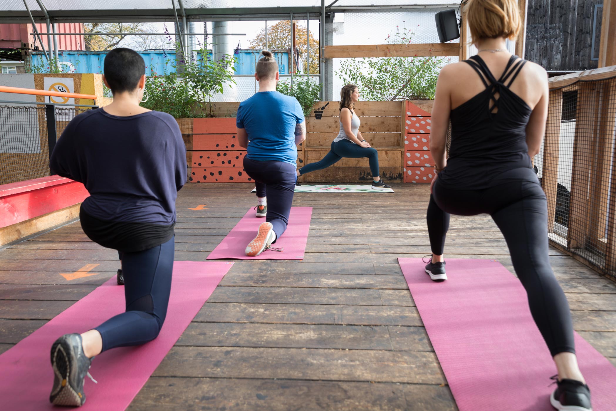 A fitness instructor leads an exercise class in Brixton, London during a personal branding photography shoot