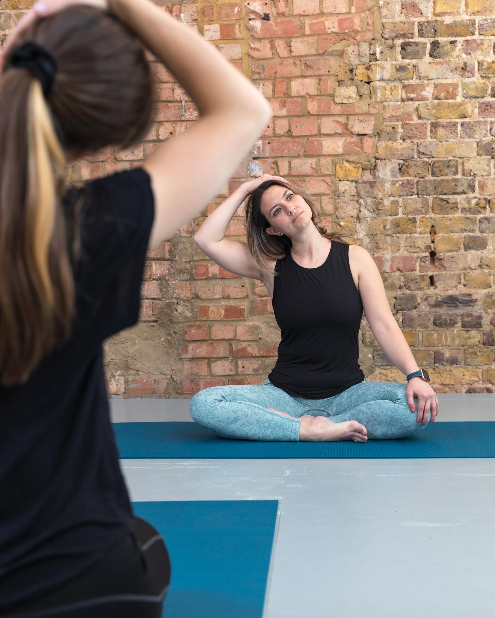 A fitness instructor leads an exercise class in London during a personal branding photography shoot