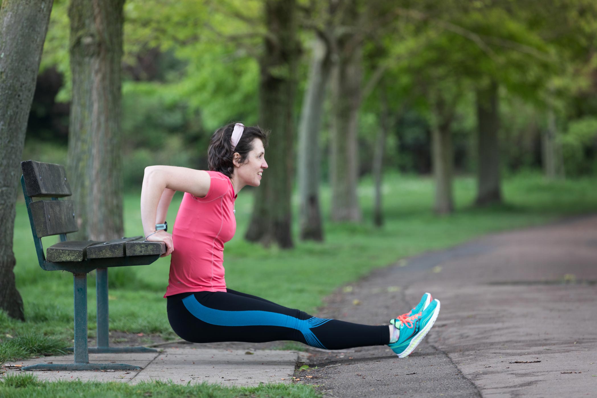 A female personal trainer works out in the park during a fitness photo shoot in London