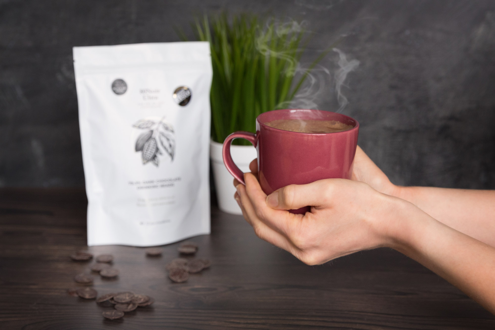 Hands holding a steaming mug of hot chocolate for London product photography