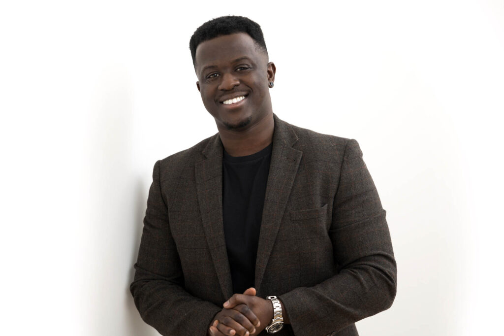 An example of what to wear for a professional headshot; a photo of a relaxed businessman in an informal suit jacket & t-shirt taken in Croydon, South East London.