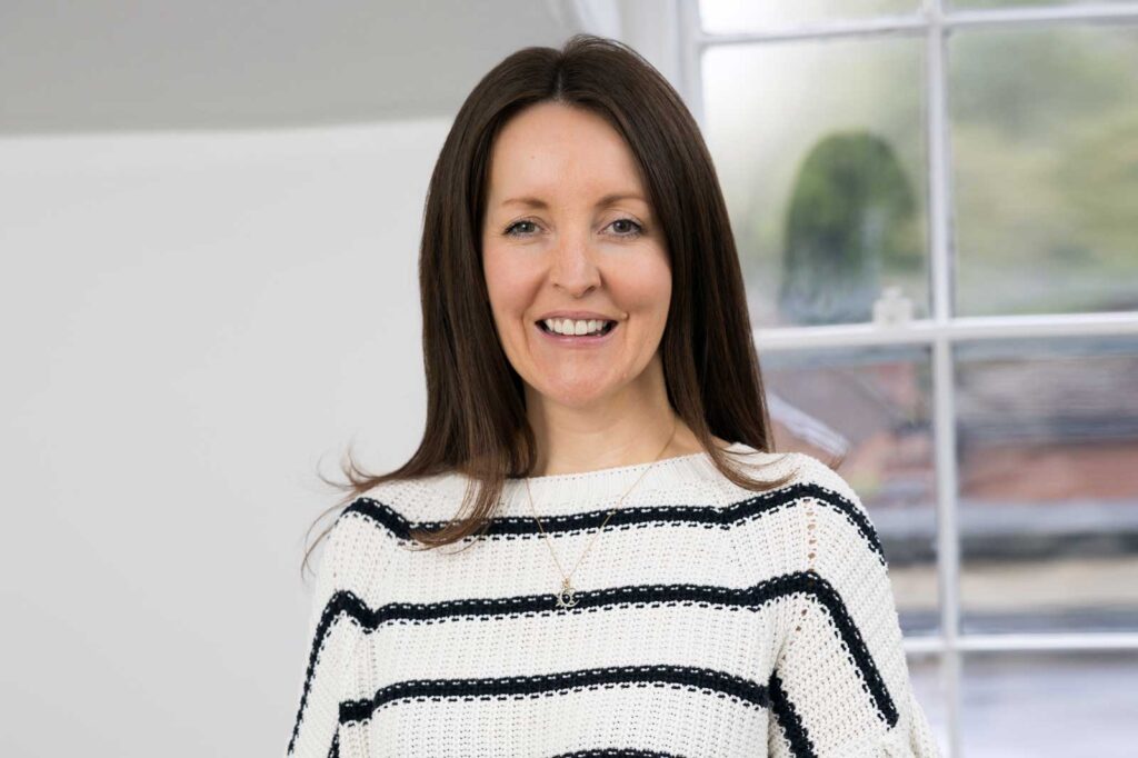 A business woman wearing a striped jumper photographed by a Surrey headshot photographer in Reigate