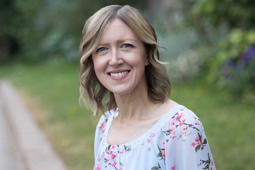 Business portrait of a female business owener in a light blue floral top